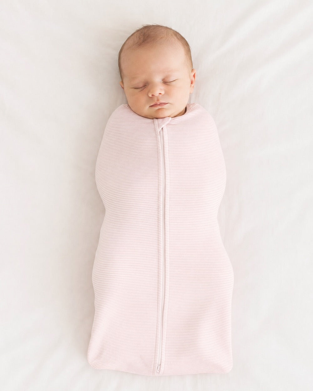 Baby swaddled, arms in